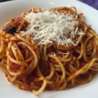 Spaghetti with vegan cheese, tomato & olive sauce at samsara restaurant in Buzios