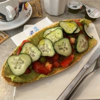 Slice of Bread with Guacamole, tomatoes, cucumbers and pickles  at Panonia Coffee in Granada