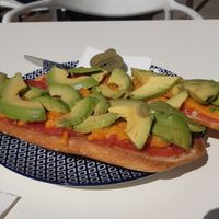 Tomato and avocado toast with vegan housemade cheese at Panonia Coffee in Granada