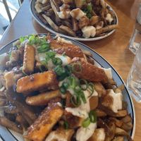 Classic poutine on top, Buffalo poutine on bottom (both large)  at Maynard in Montreal