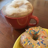 Hot cocoa with marshmallows and strawberry donut with sprinkles   at Yellow Rose Vegan Bakery in Maplewood