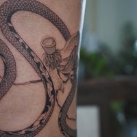 𝙄𝙂: 𝙣𝙖𝙩𝙚_𝙩𝙝𝙖𝙞𝙡𝙖𝙣𝙙 🍃 Thai Naga tattoo with dying lotus flowers by a Thai tattoo artist in Chiang Mai, Thailand at Baan Khagee Tattoo in Chiang Mai