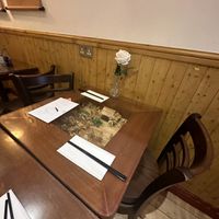 Miniature villages under the glass top tables   at Sen Viet Vegan in East London