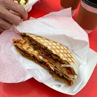 Pizza crunch wrap — like a crunchy flattened hot pocket  at Feed Your Head - Food Stand in Chicago
