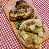 Two slices of focaccia: Aglio & oregano: garlic and oregano + Patate & Rosmarino: potatoes and rosemary  at Trevi's in Amsterdam