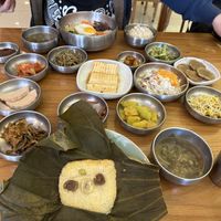 Lotus leaf rice and bibimbap with all of the side dishes   at Puleunsolmalg Eunhyang 푸른솔맑은향 in Jeju