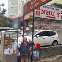 Hoa in front of her stand at Banh Mi Chay Co Hoa in Da Lat