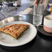 Spanakopita, coffee and waterr  at Mother Vegan Bistro in Athens