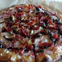 Vegan cheese, roasted garlic, sun-dried tomatoes, caramelized onions, fresh basil and balsamic glaze at Pizza Mio in Florence