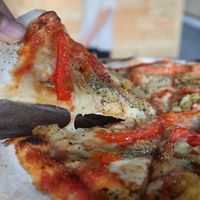 Pizza with peppers and vegan cheese at Kaya Herb House in Kingston