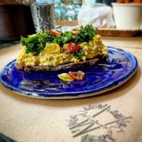 Tropical guacamole toast !! Amazing guacamole with mango and wilted kale on top  at Winners Vegan Restaurant in Athens