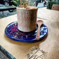 Turmeric latte with black pepper and medjool dates!! On top they have some micro rose petals bio that comes from mountain Olympus at Winners Vegan Restaurant in Athens