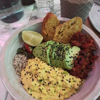Winners breakfast! Scrambled tofu smokey beans avocado cherry tomatoes sourdough turmeric and chili bread omega seeds at Winners Vegan Restaurant in Athens