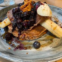 Blueberry pancakes! Simply amazing! Ripe banana blueberry sauce with no sugar, bio all purpose flour and apple puree! Toped with “hony”comb at Winners Vegan Restaurant in Athens