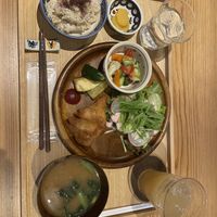 Brown rice set with 2 salad and fried chickpea samosas,fried zucchini, mushroom miso soup, pickles and apple juice.   at Seren Table in Takatsuki
