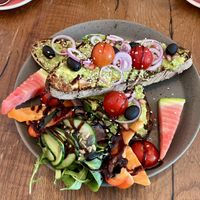 Avocado sourdough bread with salad & fruits  at EM Breakfast Club in Hamburg