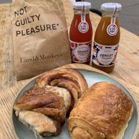 Braided cinnamon roll and traditional ‘pain au chocolat’ completed with organic juices.  at Land & Monkeys - Beaumarchais in Paris