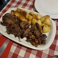 Rabit with baked potatoes   at Al Sanpietrino Trattoria in Lisbon
