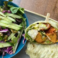 The chikin caesar wrap with a side of green salad at Vegan Street in Calgary