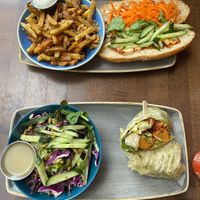 Top: The banh mi with a side of garlic fries. 
Bottom: The chikin caesar wrap with a side of green salad at Vegan Street in Calgary
