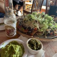 Giant nachos and a beer for scale at Sneaky Dee's in Toronto