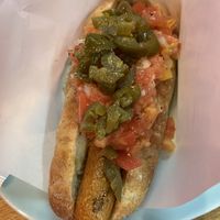 closer look of a vegan hotdog with salsa and jalapeños at Bells in Tokyo