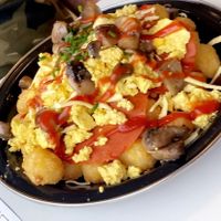 Big bowl of breakfast goodness tata tots,cheese mushrooms beans vegan bacon, scrambled tofu soooo good aand so filling Highly recommend!! at Feed Me Fully Loaded in Nottingham