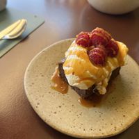 Brownie with chantilly cream, fresh raspberries and salted caramel. Excellent !  at Kukicha in Leiria