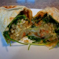 Harissa Wrap. New item, looked vegan minus the feta but not marked. Lemon couscous, arugula, carrots, hummus, spicy harissa vinaigrette, golden raisins, sumac spice  at CLE - Currito - Main Terminal in Cleveland