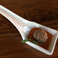 Amuse Bouche - Forbidden rice Swedish style meatball with micro cilantro in marinara. at Encuentro in Oakland
