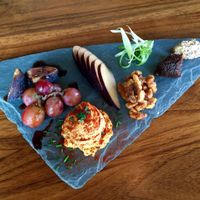 Sharp cashew cheese plate with fig chutney, grain mustard, walnut 'honey', seasonal fruit. at Encuentro in Oakland