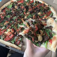 Mushroom garlic pizza with added spinach and red sauce, and substituted daiya cheesee  at Pies & Pints in Fayetteville