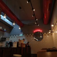 Indoor sitting area at Moto La Pizza in Ramat Gan