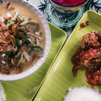 Coconut curry and "tofu steak" which was more like vegan meatballs. Both dishes were very tasty. at Buddha Cafe in Samosir