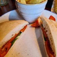 Hummus, roast pepper and spinach roll with chips at Wighton in Torquay
