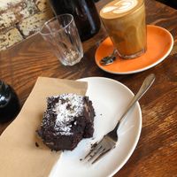 Vegan chocolate brownie and a beautiful almond latte. Such a peaceful atmosphere in this little hidden gem :) at Monk Bodhi Dharma in Balaclava