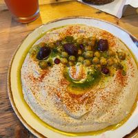 Humus clássico com paprika, azeitonas e pão caseiro  at Honest Greens in Lisbon