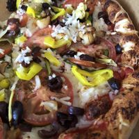 Vegan Mediterranean pie with classic crust, no feta, add roasted garlic and artichoke 😋  at PizzAmore in Grand Junction