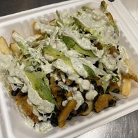 Cali loaded fries - cheesy soy curls, black beans, avocado, lettuce & ranch on fries at Nom Eats with Seats in Reno