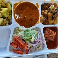 Veg thali with dry potatoes, Chana masala, an eggplant curry, and Manchurian chaap at Chat Hut in Malton