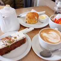 Pot of Earl Grey tea, flat white, carrot cake, scone with vegan butter. All very very good 😋 at Leaf & Bean in Broadway