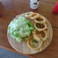 Protein burger wrapped in lettuce and onion rings at Herbivoro in Cancun