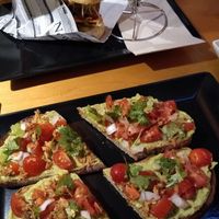 Bruschetta with the hot dog in the background at The Botanical Den in Lisbon