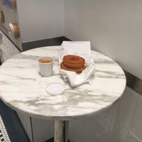 Seating inside, with donut and coffee at The Donut Pub - Astor Place in New York City