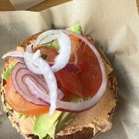 Coast to coast with tomato and herb cream cheese, on an onion bagel  at Seize the Bagel in Vancouver