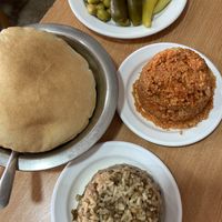 Pitas, tomato burgul, magadra (rice and lentils mix), pickles (go with hummus)  at Abu Shaker in Haifa