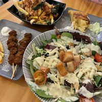Patatas gordiveganas, tortilla de patatas, pinchito moruno and ensalada de cesar at La Vegana Taperia in Malaga