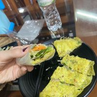 A thin pancake with bean sprouts fried inside for the vegan option😄 extra greens and pickled veg on the side. Rice paper included too😄all for 30k   at Thuy Di Quan My Quang in Ha Giang