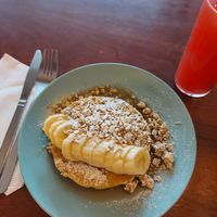 Vegan pancakes stack with banana, granola and maple syrup at O Diplomata in Porto