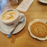 Vegan cappuccino with soy milk and a vegan peanut butter cookie at MUG in Trieste